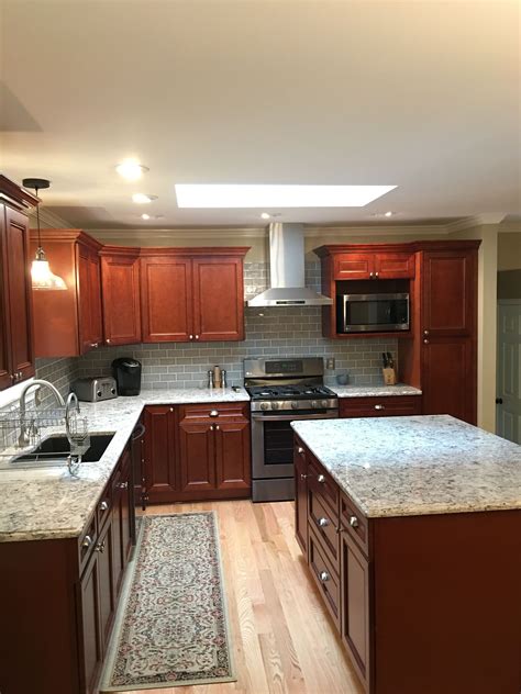 white countertops with cherry cabinets